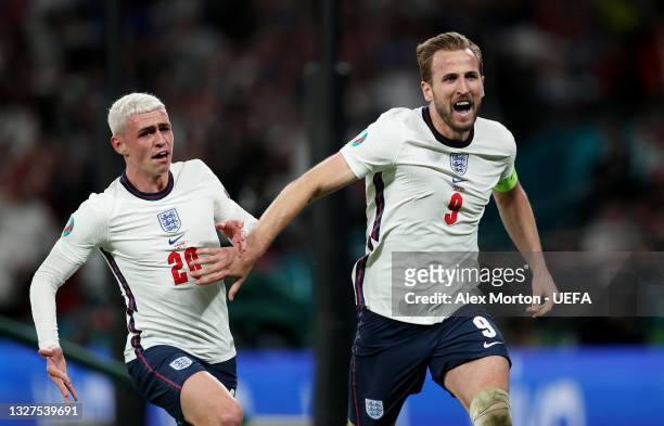 Harry Kane of England celebrates with teammate Phil Foden after scoring their team's second goal during the UEFA Euro 2020 Championship Semi-final...