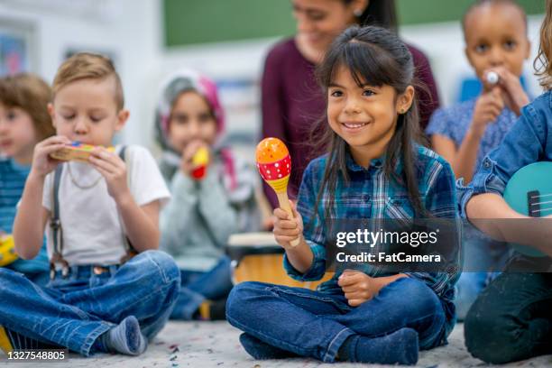 kids playing music in preschool - maraca stock pictures, royalty-free photos & images