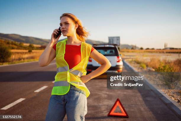 woman calling car assistance - reflective clothing road stock pictures, royalty-free photos & images