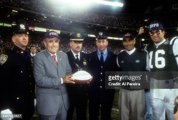 Head Coach Herman Edwards of the New York Jets wears an FDNY cap when he presents a game ball dedicated to The City of New York to Mayor Rudolph...