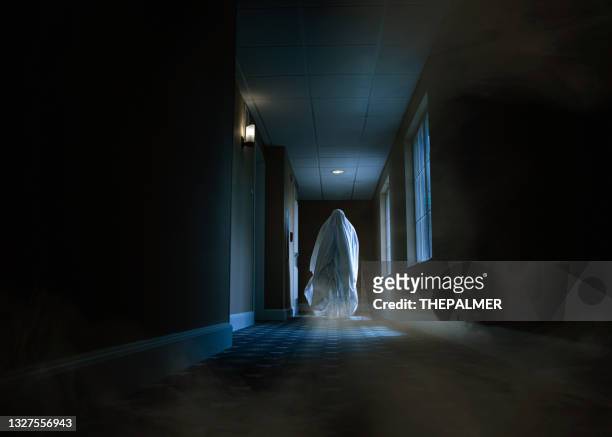 spooky ghost moving alongside a hotel corridor - spooky stock pictures, royalty-free photos & images