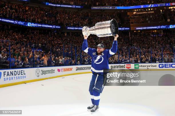 Steven Stamkos of the Tampa Bay Lightning hoists the Stanley Cup after the 1-0 victory against the Montreal Canadiens in Game Five to win the 2021...