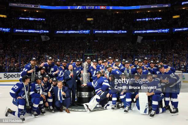 The Tampa Bay Lightning pose with the Stanley Cup after defeating the Montreal Canadiens 1-0 in Game Five to win the 2021 NHL Stanley Cup Final at...