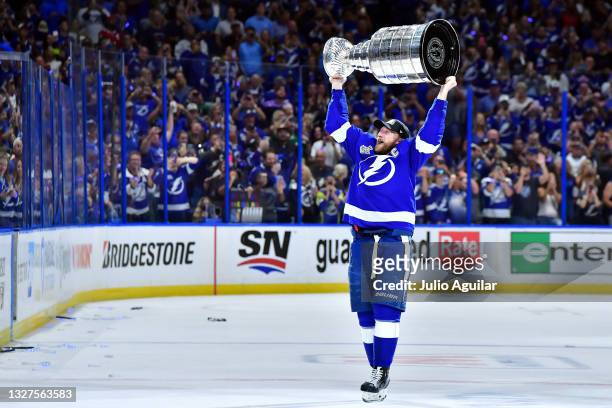 Steven Stamkos of the Tampa Bay Lightning hoists the Stanley Cup after the 1-0 victory against the Montreal Canadiens in Game Five to win the 2021...