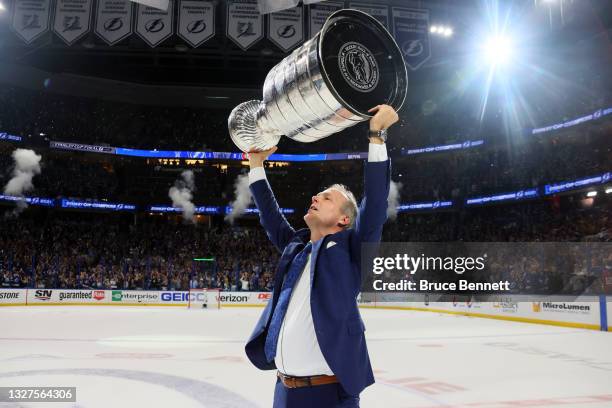 Head coach Jon Cooper of the Tampa Bay Lightning hoists the Stanley Cup after the 1-0 victory against the Montreal Canadiens in Game Five to win the...