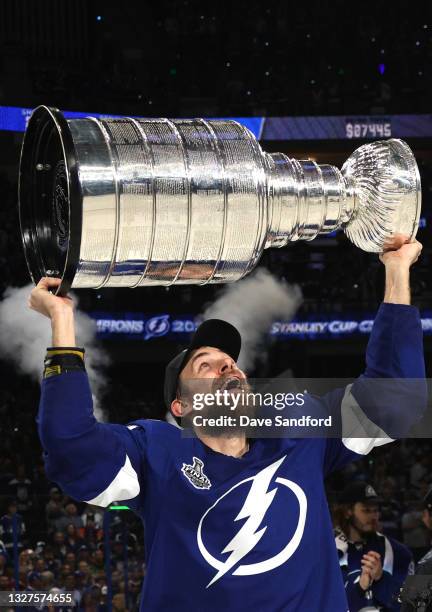 Jan Rutta of the Tampa Bay Lightning hoists the Stanley Cup after their 1-0 victory in Game Five of the 2021 Stanley Cup Final to win the series four...