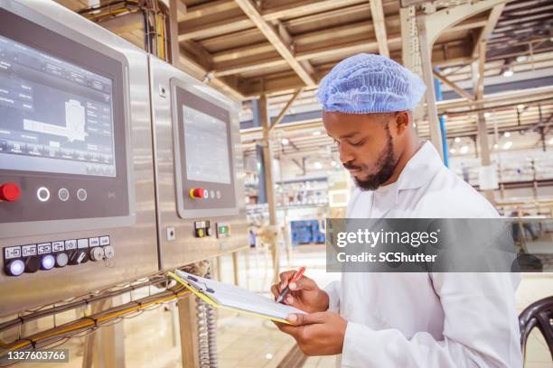 african / zambian factory workers monitoring electrical panel in beverages factory factory - lusaka bildbanksfoton och bilder