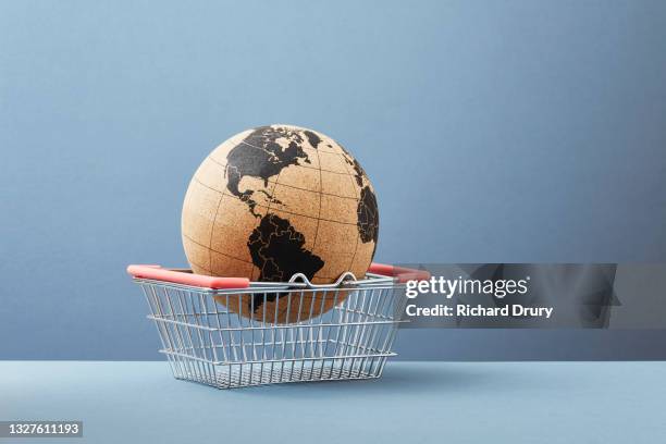 a world globe in a shopping basket - convenience basket stock pictures, royalty-free photos & images