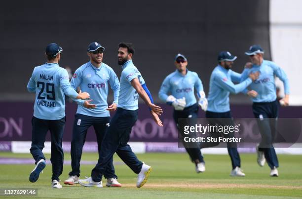 England bowler Saqib Mahmood celebrates with team mates after taking the wicket of Babar Azam caught by Zak Crawley for 0 during the 1st Royal London...