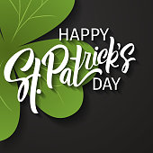 Happy St. Patrick's Day greeting. Lettering St. Patrick's Day on a dark background with shamrock.