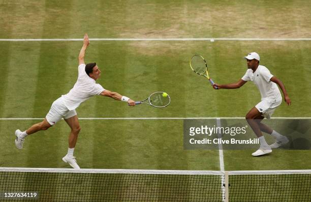 Joe Salisbury of Great Britain, playing partner of Rajeev Ram of The United States plays a backhand in their Men's Doubles Semi-Final match against...