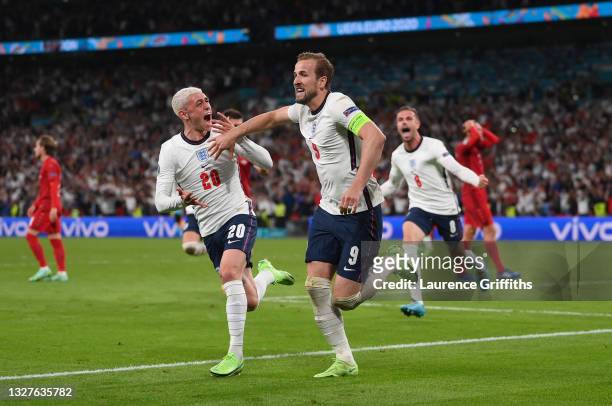 Harry Kane of England is congratulated by Phil Foden after scoring the second goal during the UEFA Euro 2020 Championship Semi-final match between...