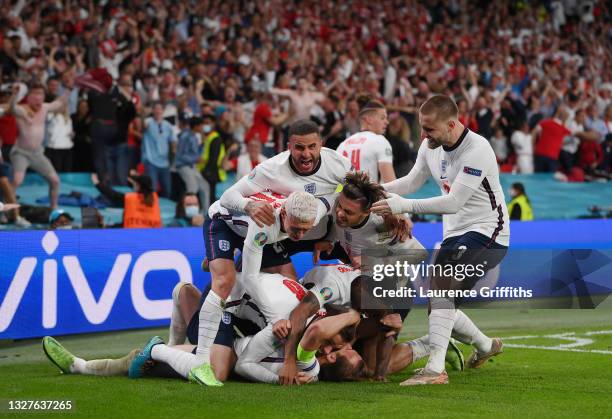 Harry Kane of England is congratulated after scoring his team's second goal by Jordan Henderson, Phil Foden, Kyle Walker, Jack Grealish, Raheem...