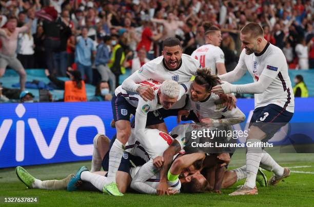 Harry Kane of England is congratulated after scoring his team's second goal by Jordan Henderson, Phil Foden, Kyle Walker, Jack Grealish, Raheem...