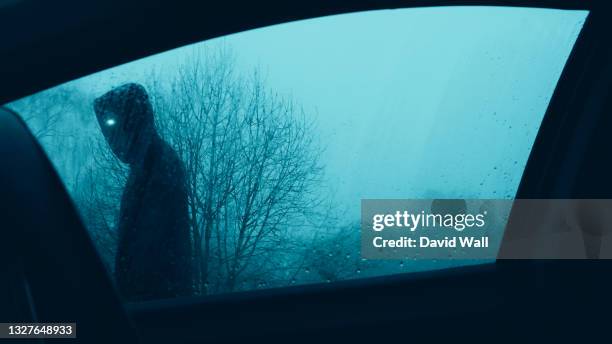 a horror concept. looking up through a car window at a scary supernatural entity with glowing eyes, walking past a car. on a moody winters evening. - creepy monsters from the past stock pictures, royalty-free photos & images