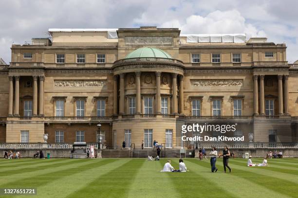 Visitors walk on the lawn in the newly opened gardens at Buckingham Palace on July 08, 2021 in London, England. The gardens will be open from...