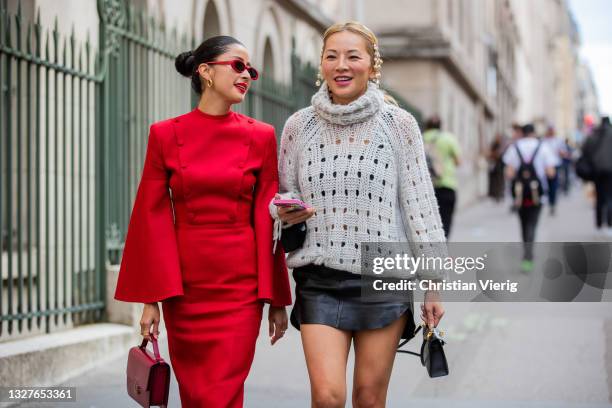 Guest is seen wearing red top and skirt, bag and Tina Leung wearing jumper and black skirt outside Zuhair Murad on July 07, 2021 in Paris, France.