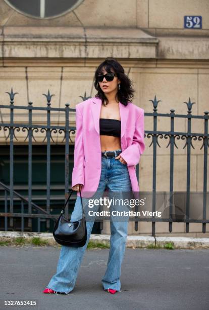 Xiayan is seen wearing pink blazer, cropped top, prada bag, denim jeans outside Zuhair Murad on July 07, 2021 in Paris, France.