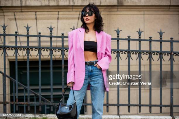 Xiayan is seen wearing pink blazer, cropped top, prada bag, denim jeans outside Zuhair Murad on July 07, 2021 in Paris, France.