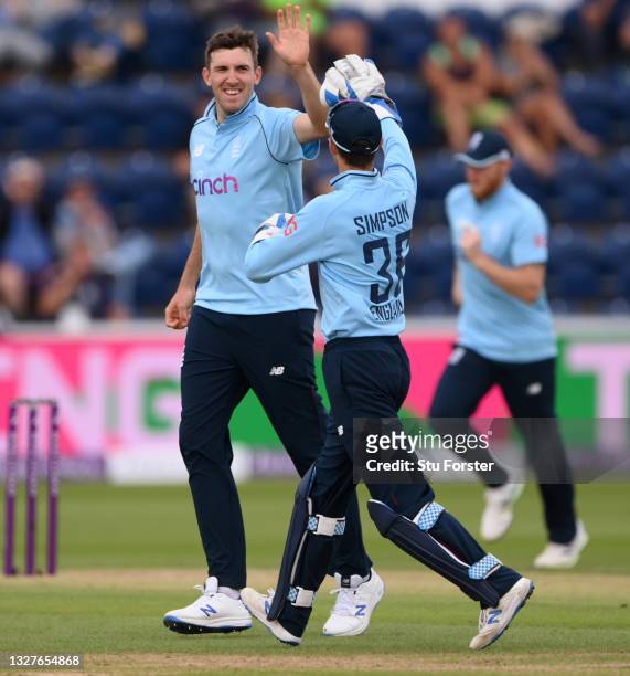 England bowler Craig Overton in celebrates with team mates after taking the wicket of Pakistan batsman Shadab as Shaheen Shah Afridi looks on during...