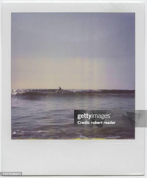 polaroid photograph of surfer riding a wave - polaroid stock-fotos und bilder