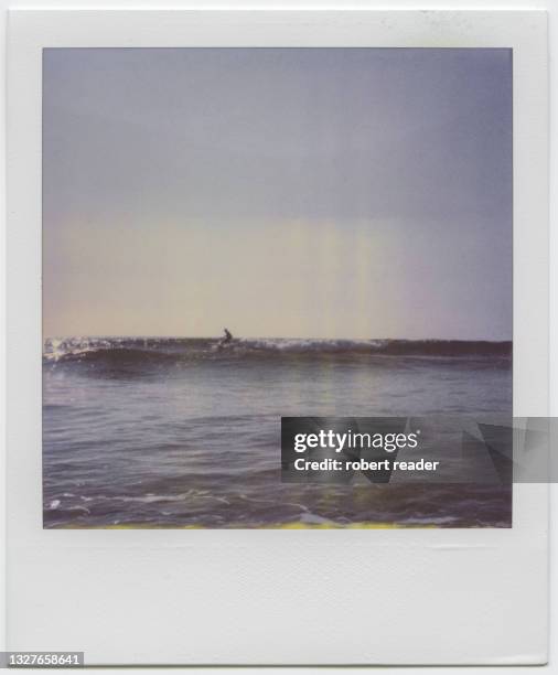 polaroid photograph of surfer riding a wave - polaroid stockfoto's en -beelden