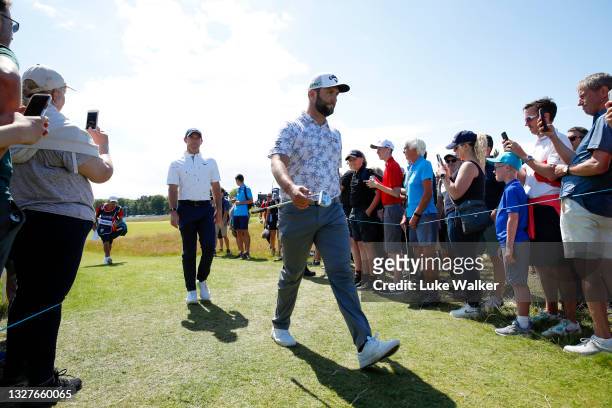 Jon Rahm of Spain and Rory McIlroy of Northern Ireland walk to the 6th tee during Day One of the abrdn Scottish Open at The Renaissance Club on July...