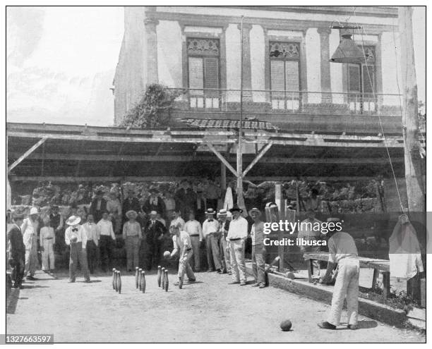 antique black and white photograph: a game of "bolara", puerto rico - bowling stock illustrations