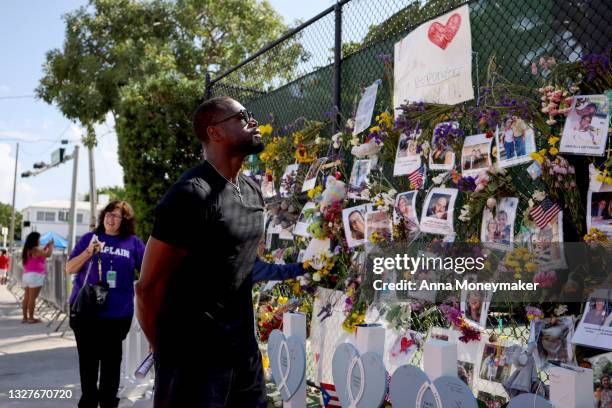 Former NBA player Dwyane Wade of the Miami Heat pays his respects at the memorial site for victims of the collapsed 12-story Champlain Towers South...