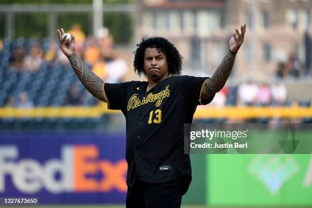 Zach Banner of the Pittsburgh Steelers waves to the crowd before throwing out the first pitch before the game between the Pittsburgh Pirates and the...