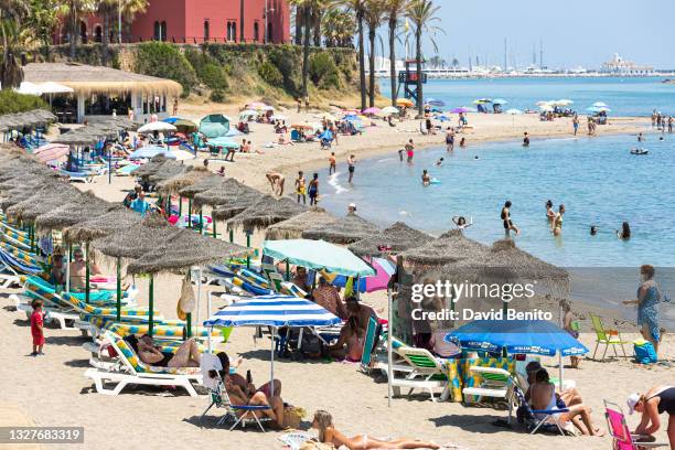 People play in the sea as they enjoy the hot weather at the beach on July 8, 2021 in Benalmádena, near Málaga, Spain. AEMET reported that Andalusia...