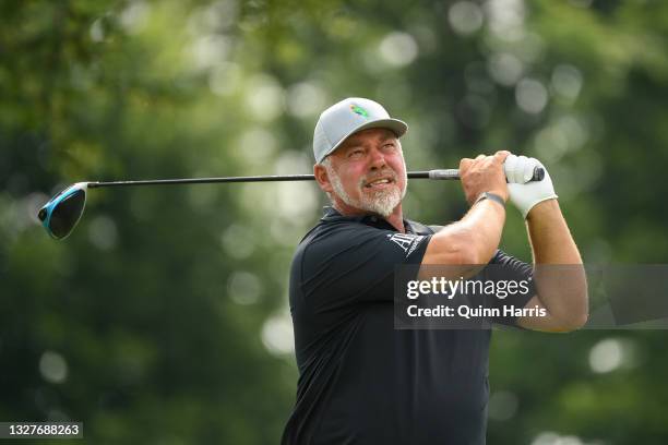 Darren Clarke of Northern Ireland plays his shot from the ninth tee during the first round of the U.S. Senior Open Championship at the Omaha Country...