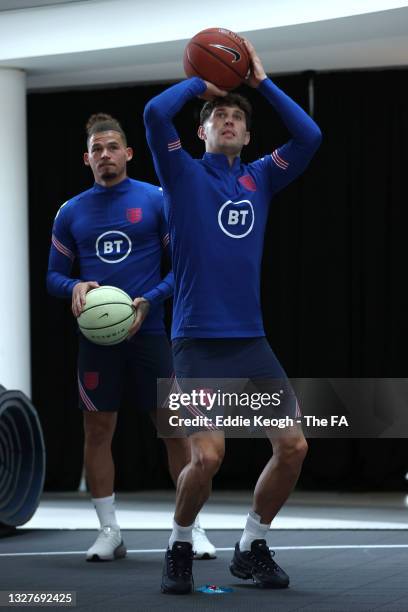 Kalvin Phillips and John Stones of England play basketball at St George's Park on July 08, 2021 in Burton upon Trent, England.