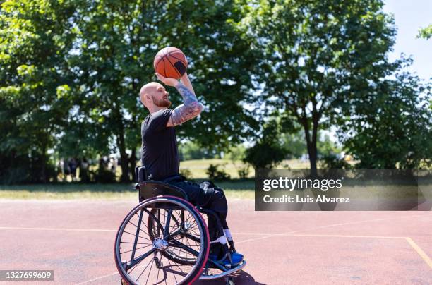 wheelchair basketball player in action on court - basket sport stock pictures, royalty-free photos & images