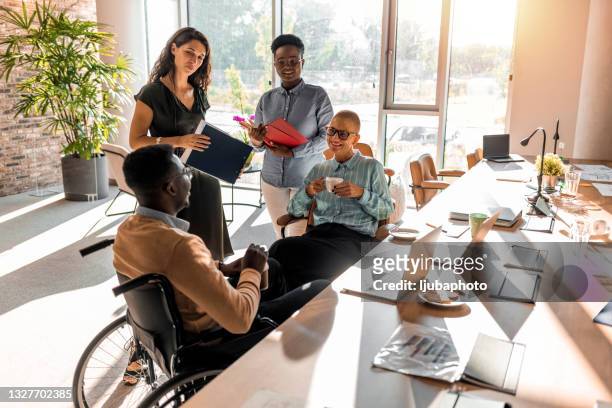 aged businesswoman, teacher or business coach speaking to young people - multiracial group stock pictures, royalty-free photos & images