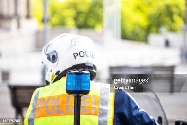 german policeman on a motocycle - police uniform stock pictures, royalty-free photos & images