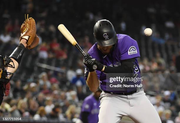 Cron of the Colorado Rockies is hit in the head with a pitch from Riley Smith of the Arizona Diamondbacks during the seventh inning at Chase Field on...