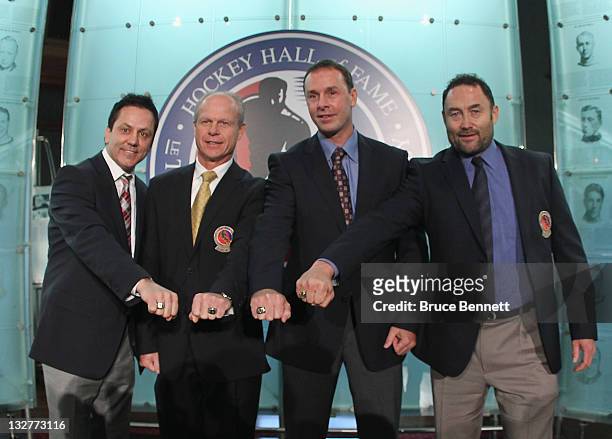 Hall of Fame inductees Doug Gilmour, Mark Howe, Joe Nieuwendyk and Ed Belfour show off their Hall of Fame rings during a photo opportunity at the...