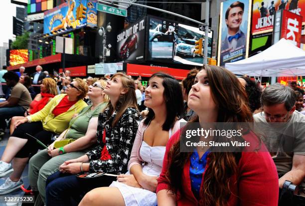 Fans attend the Times Square simulcast of the 65th Annual Tony Awards in Times Square on June 12, 2011 in New York City.