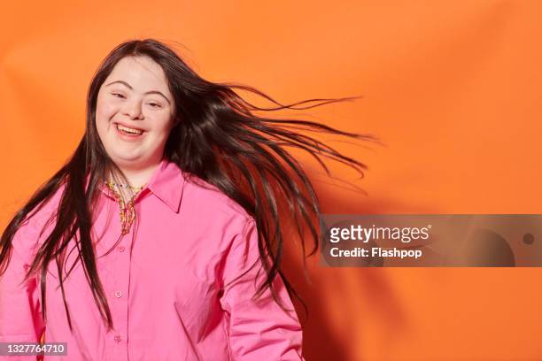 portrait of young woman laughing - disabilitycollection stock pictures, royalty-free photos & images