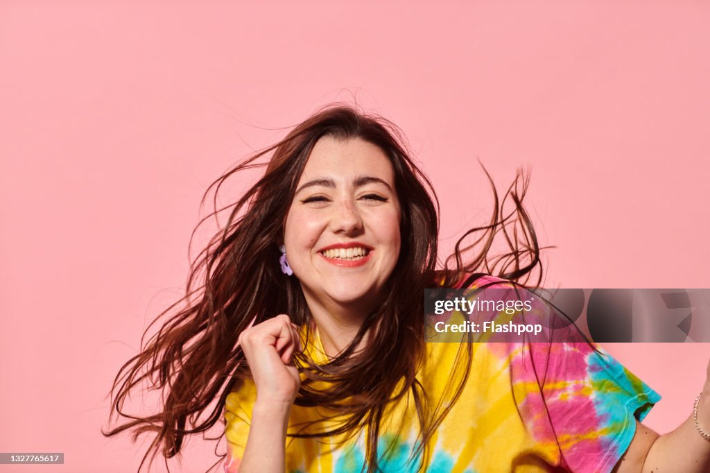 Portrait of happy, confident young woman dancing