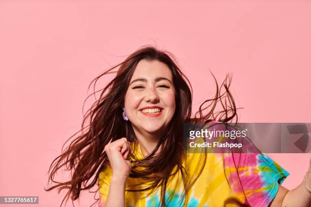 portrait of happy, confident young woman dancing - tie dye stock pictures, royalty-free photos & images