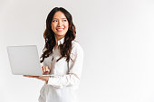 Smiling young asian businesswoman standing
