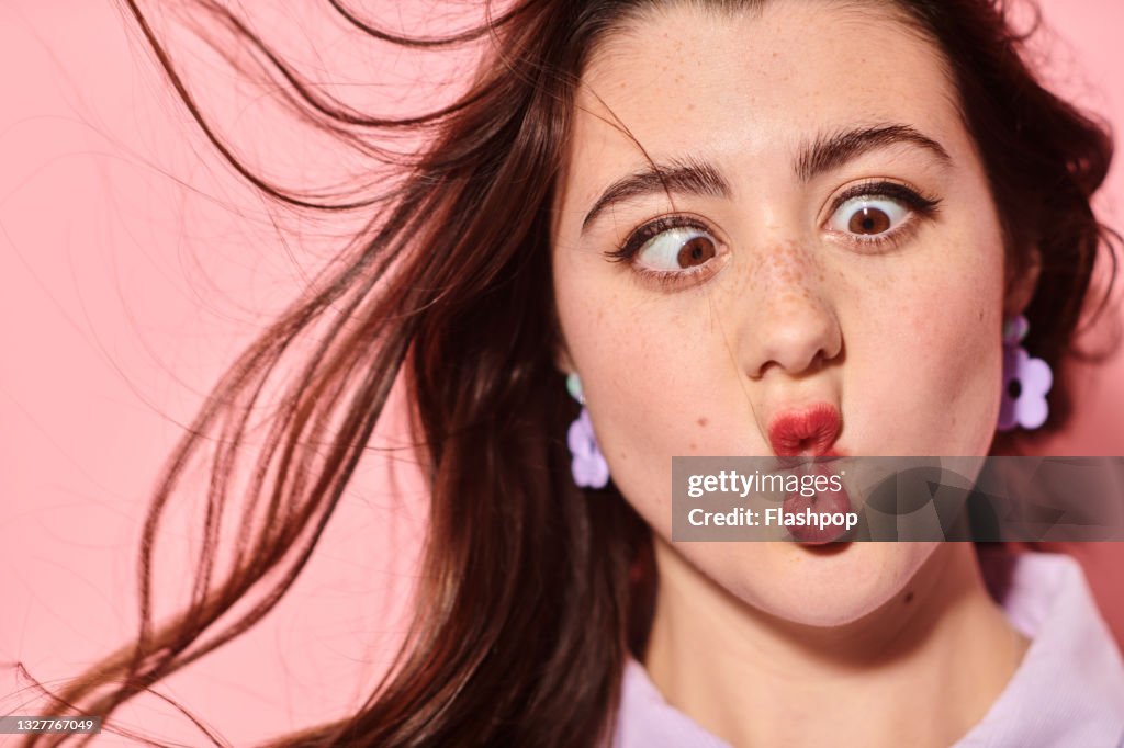 Close of of young woman pulling a funny face