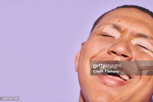 portrait of happy, confident young man laughing - visual impairment - fotografias e filmes do acervo