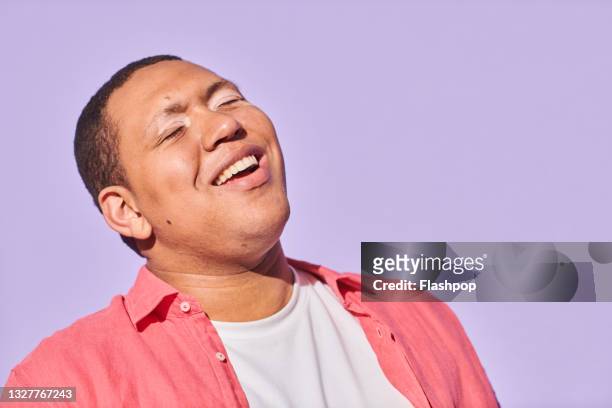 portrait of happy, confident young man laughing - disabilitycollection stock pictures, royalty-free photos & images