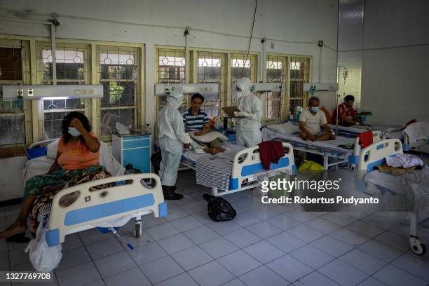 Medical staff check the COVID-19 patients at Indrapura Emergency Field Hospital on July 09, 2021 in Surabaya, Indonesia. Indonesia on Tuesday...