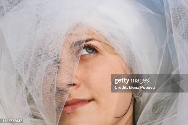 confidence young woman playing with veil and looking away - ehe gleichberechtigung stock-fotos und bilder