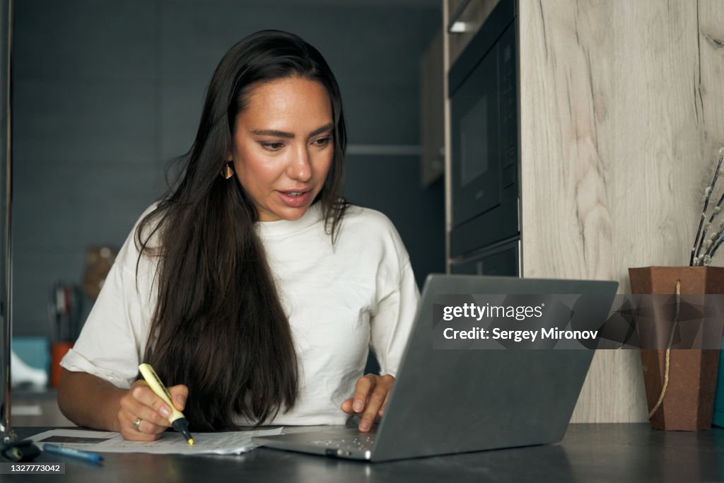 Woman working on laptop at home