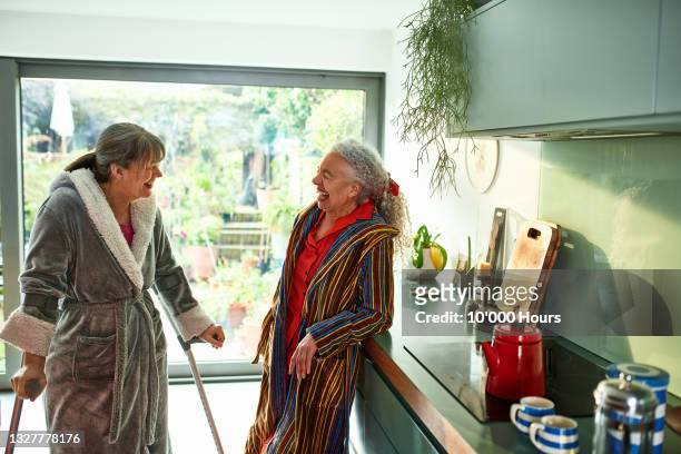 Two flatmates laughing and smiling in kitchen